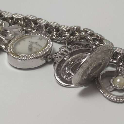Anne Klein Women’s Stainless Steel Charm Bracelet Watch close up locket